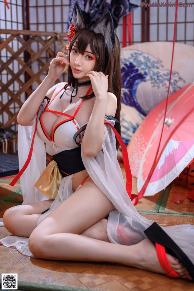 A woman in a kimono sitting on the floor with an umbrella.