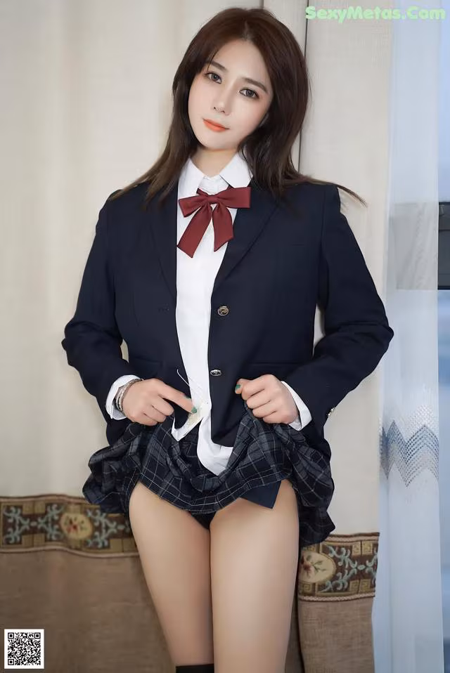 A woman in a school uniform posing for the camera.