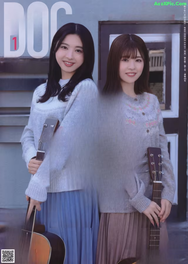 A couple of young women standing next to each other holding guitars.